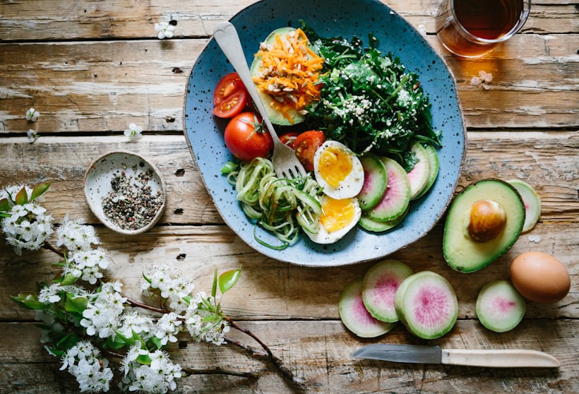 Fresh vegetables and whole foods on a kitchen table